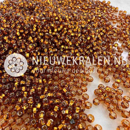 Preciosa rocailles 8/0 (3mm) topaz silverlined – Tsjechische glaskralen in transparant topaas (bruin) met zilverkleurige kern, voor sieraden en borduren.
