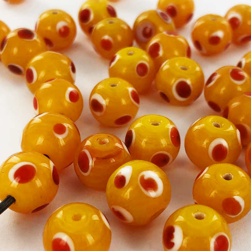 Glaskralen rond 10mm oranje kralen met stippen wit rood per 5 stuks